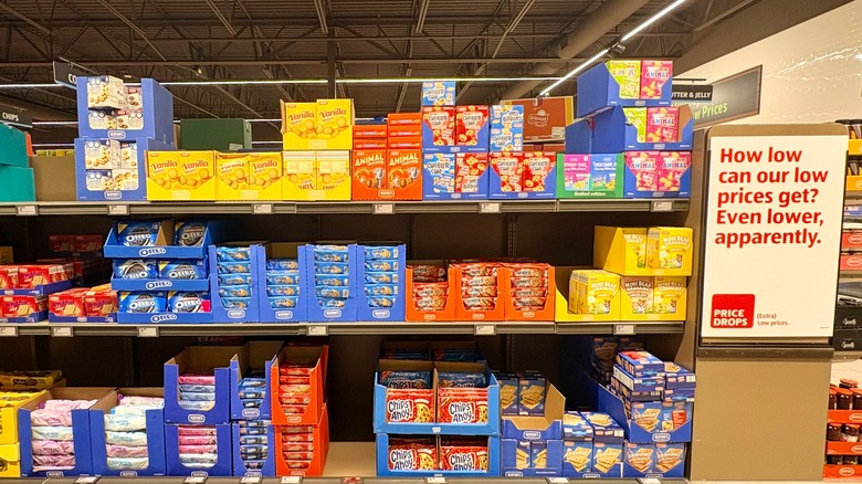 A shelf of cookies at Aldi next to a sign advertising low prices