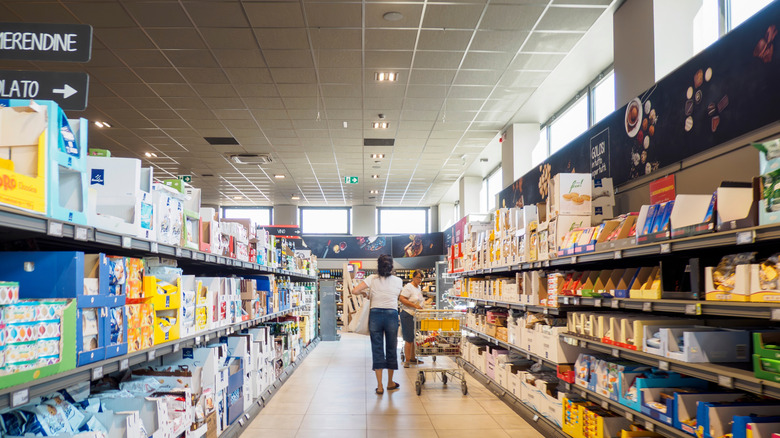 People shopping at an Aldi grocery store in the snack aisle