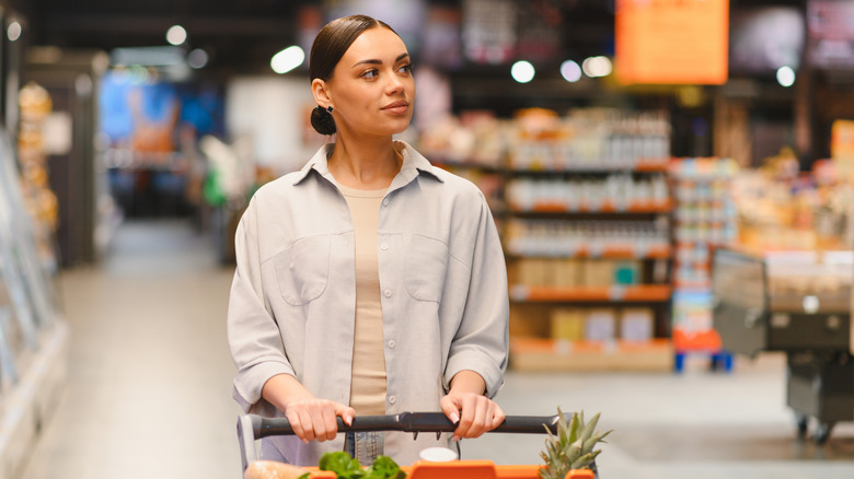 Woman pushing a grocery cart