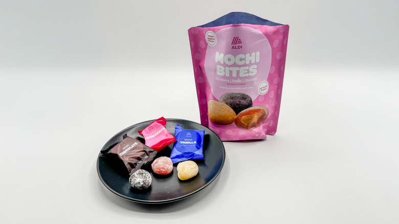 Three mochi bites on a plate with packaging