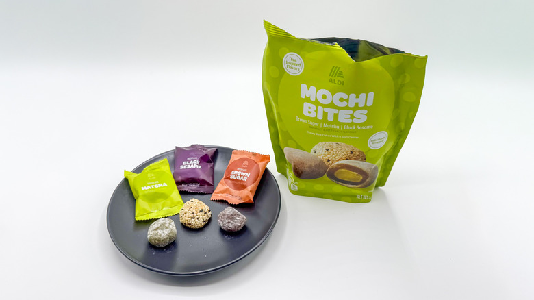 Three mochi bites on a plate with packaging