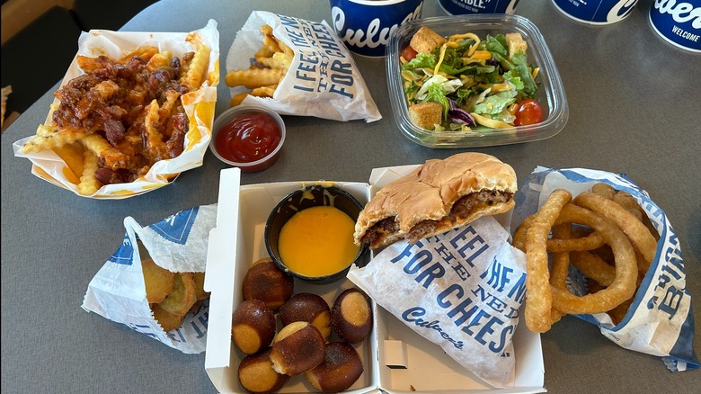 Partially eaten side dishes and ButterBurger from Culver's