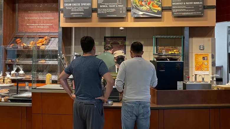 Customers placing an order at a Panera counter