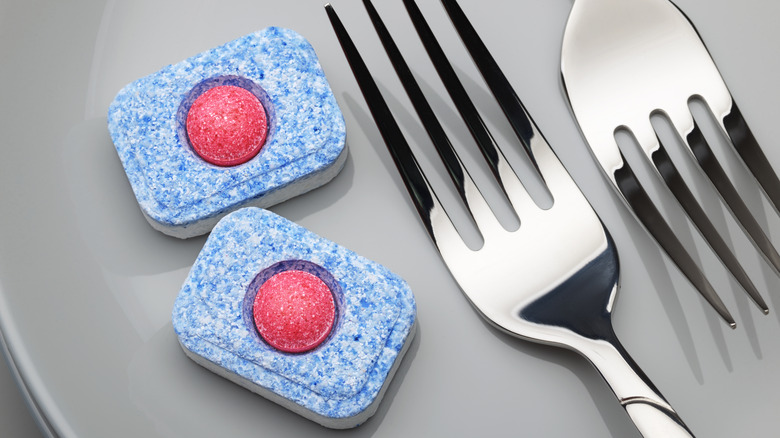 dishwasher tablets next to silverware