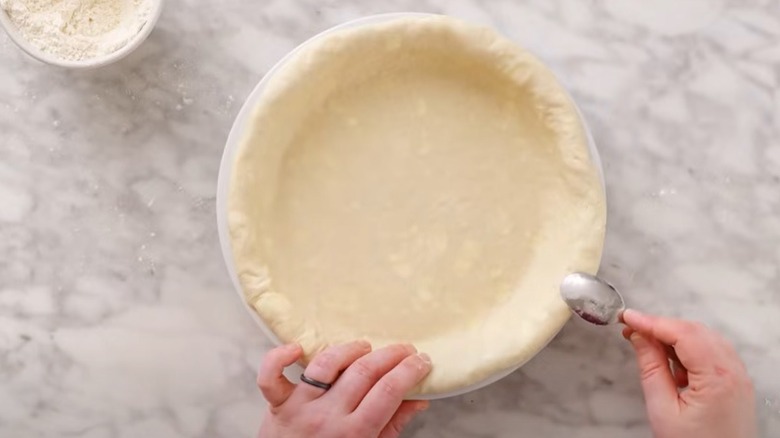 Using spoon to scallop pastry