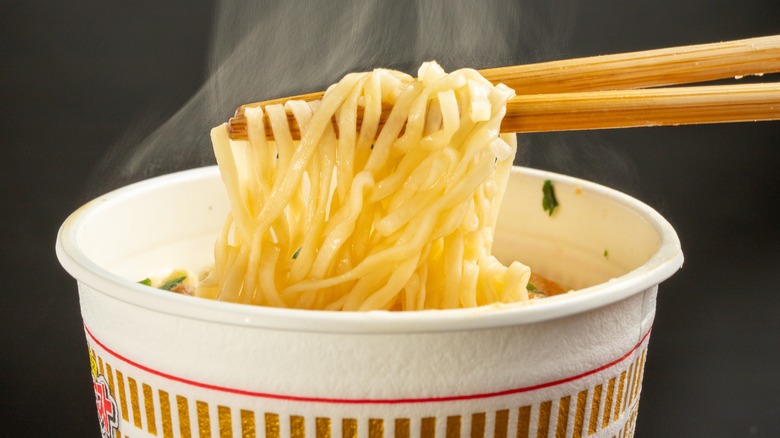 Ramen noodles held up by chopsticks