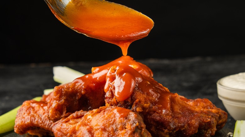 saucing Buffalo wings