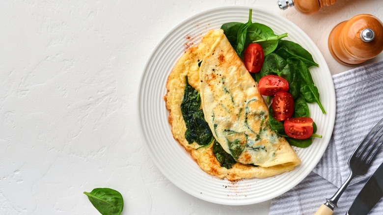 Spinach omelette on plate with salad