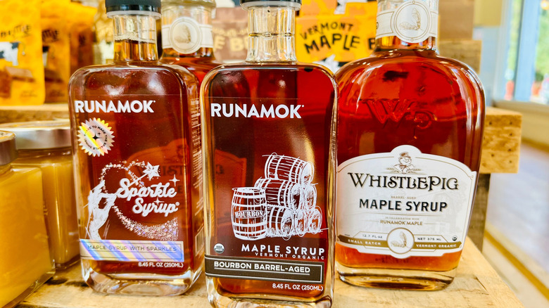 Bottles of rye whiskey on wooden table