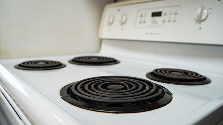 Person placing grates on stove