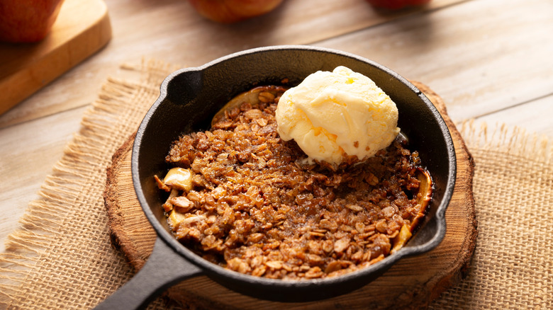 Apple crisp and ice cream in a cast iron pan