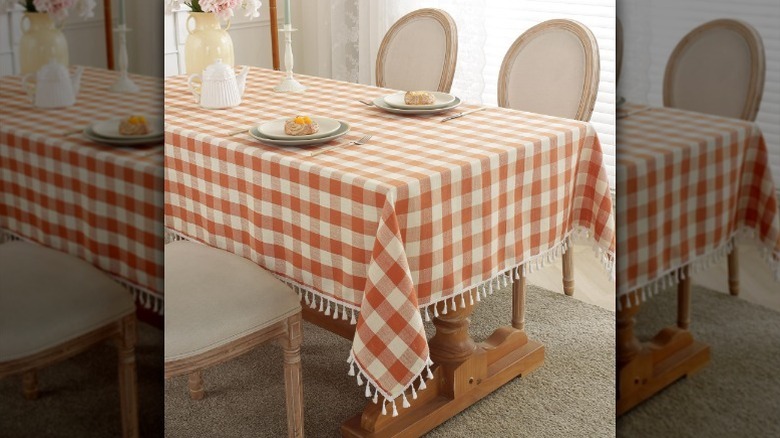 Orange and white checkered tablecloth with place settings