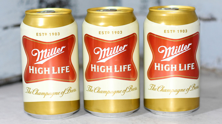 Three Miller High Life cans