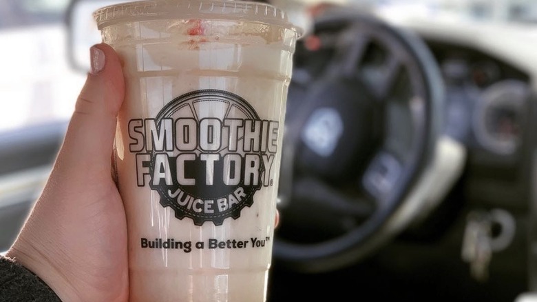 Holding a Smoothie Factory cup