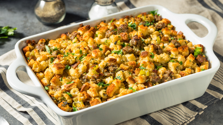 A white casserole dish filled with pork sage stuffing