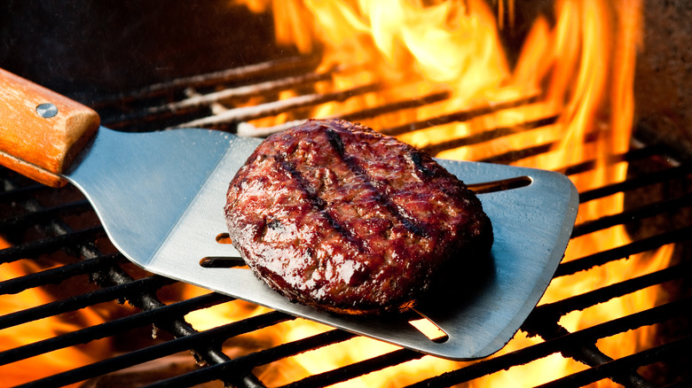A grilled burger on a spatula