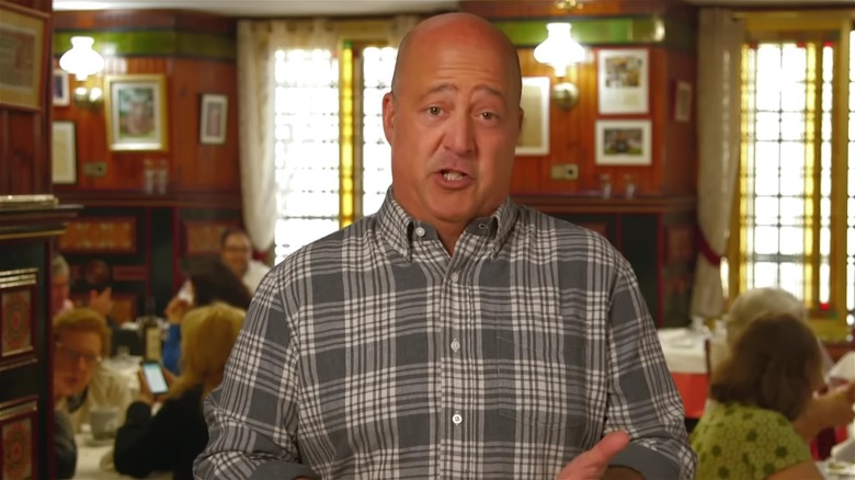 Andrew Zimmern talking in restaurant