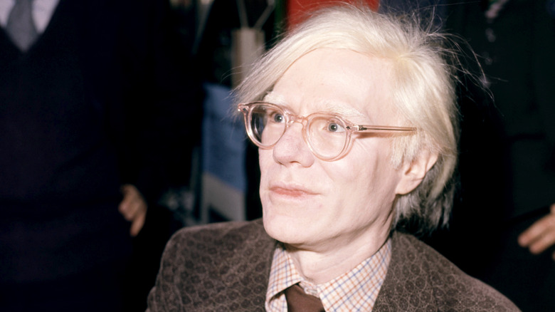 Close-up of Andy Warhol at event.