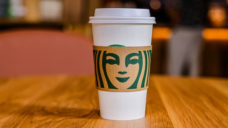 Starbucks grande cup on barista counter