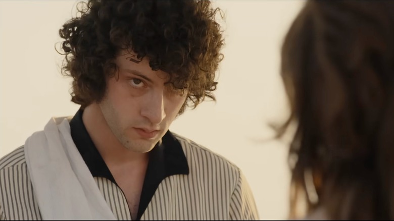 Dominic Sessa as Anthony Bourdain looking at Emilia Jones