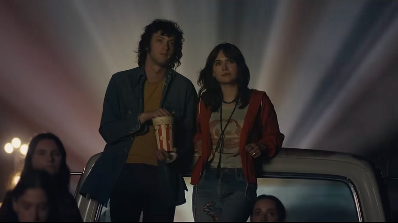 Dominic Sessa as Anthony Bourdain watching a movie with Emilia Jones