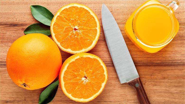 Cut orange, knife, and orange juice 