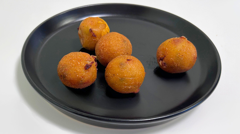 Texas Roadhouse Rattlesnake Bites on a black plate against a white background
