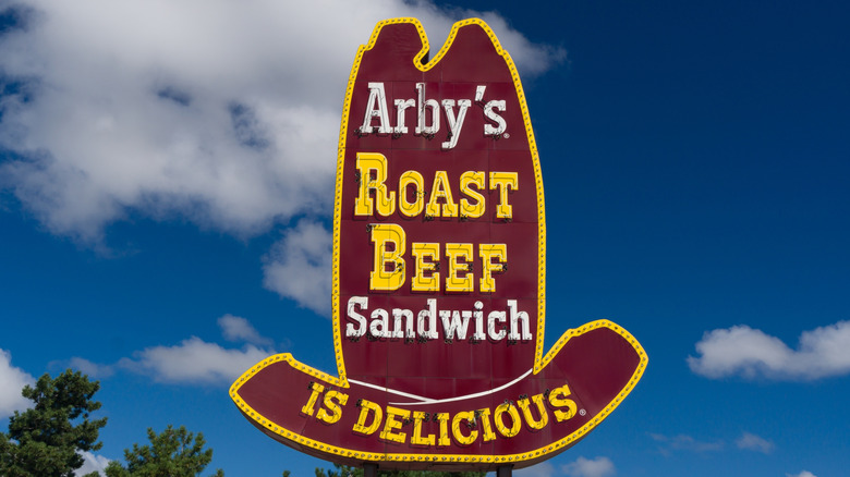 huge iconic hat-shaped sign reading Arby's Roast Beef Sandwich Is Delicious