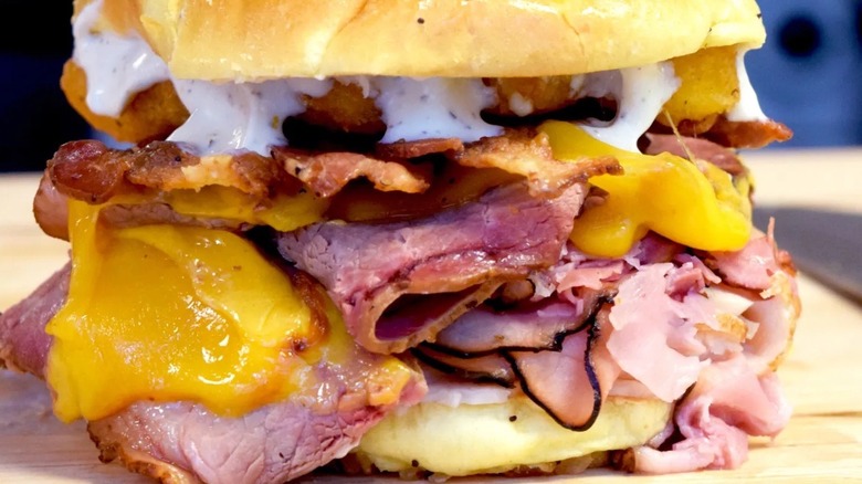 the Big Iowa sandwich with three meats, mozzarella sticks, bacon, cheese, and sauce