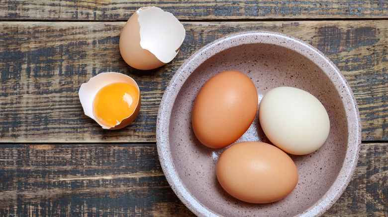 brown and white eggs in a bowl