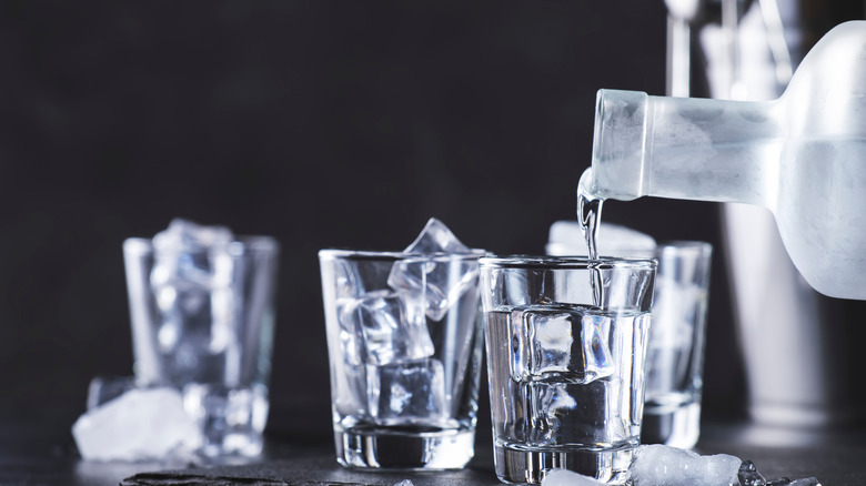 Vodka being poured into shot glasses