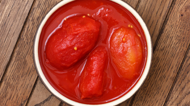 Bowl of canned plum tomatoes in juice