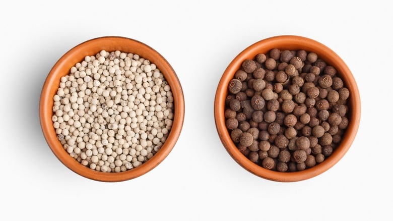 bowls of black and white pepper