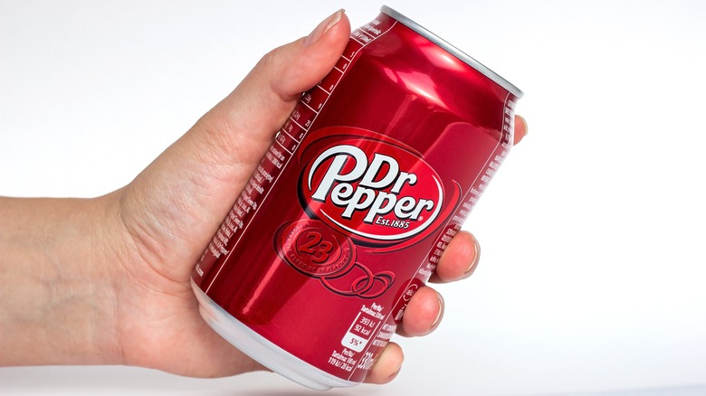 hand holding dr pepper can