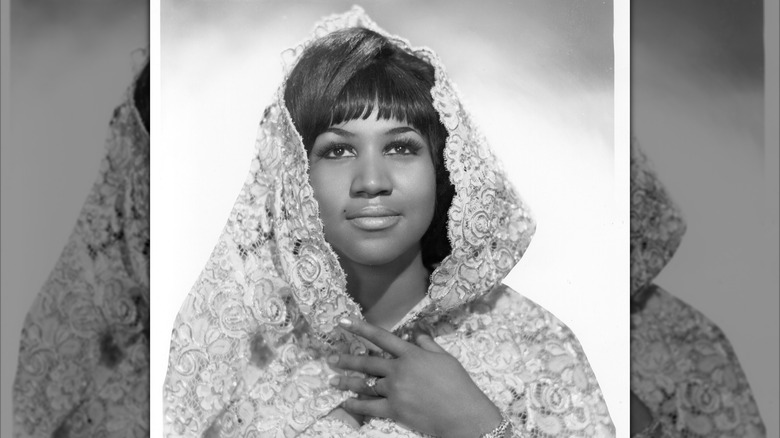 Black and white photo of Aretha Franklin posing in a lacy shroud, circa 1967.