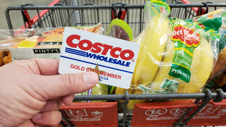Costco shopper holding membership card