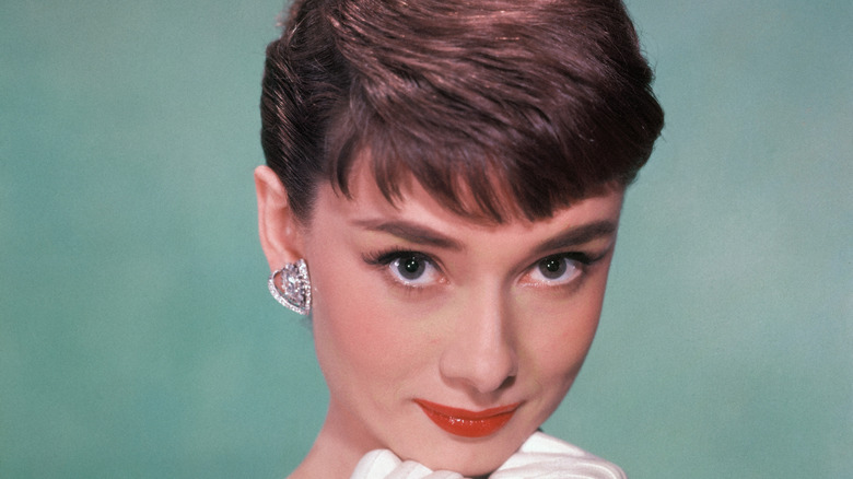 Audrey Hepburn headshot on green background