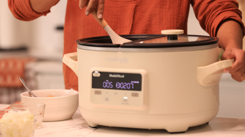 Woman mixing food in Crock Pot