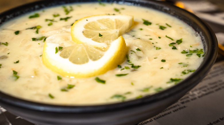 Avgolemono Greek lemon egg sauce in a bowl with lemon