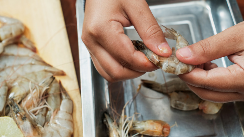 Woman peeling shrimp