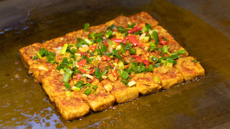 Seasoned tofu on griddle