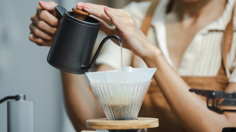 person making pour over coffee