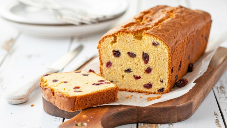 sliced cranberry pound cake on cutting board