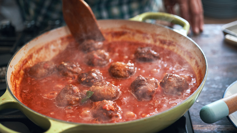 meatballs simmering in tomato sauce