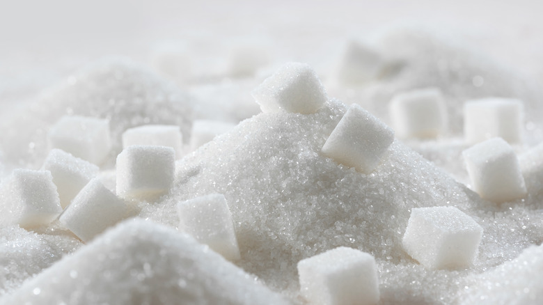 Sugar cubes lying on a pile of granulated sugar