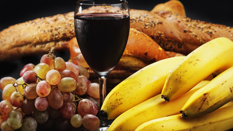 glass of wine with grapes and bananas