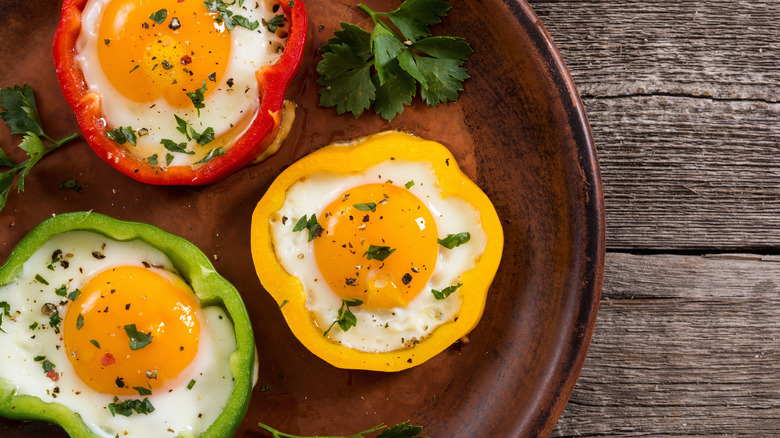 Eggs sunny side up in bell pepper rings with parsley