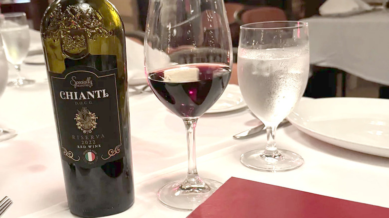 Bottle and glass of Chianti on a restaurant dining table