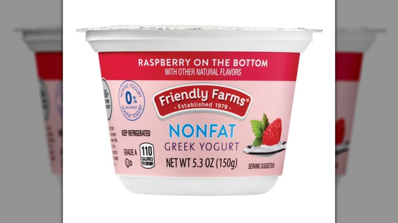 Aldi's Friendly Farms Nonfat Greek Yogurt with raspberry on a white background