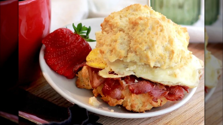 Ham and cheese on biscuit sandwich with strawberry garnish